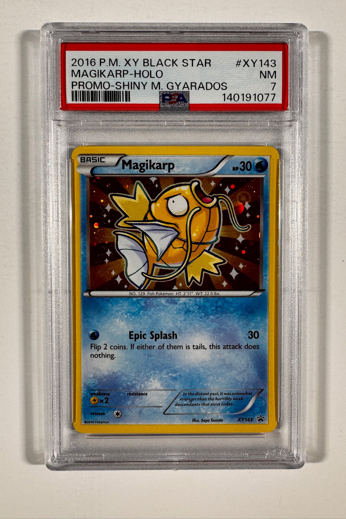 Front of PSA 7 NM graded 2016 Pokemon XY Black Star Promo Shiny Magikarp Holo card XY143.
