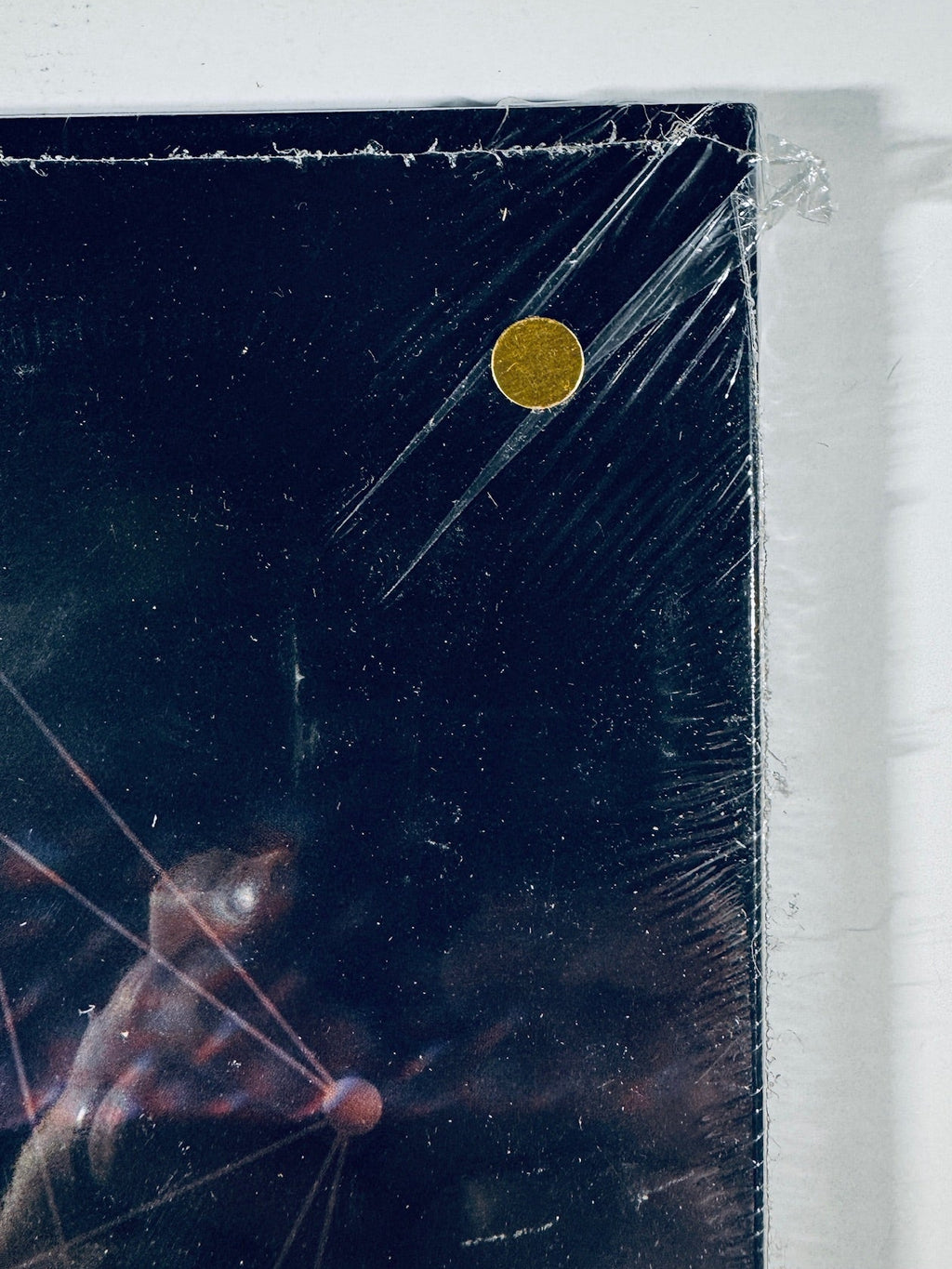 Close-up of the shrink wrap corner on the unofficial gold vinyl release of Tool's Fear Inoculum.