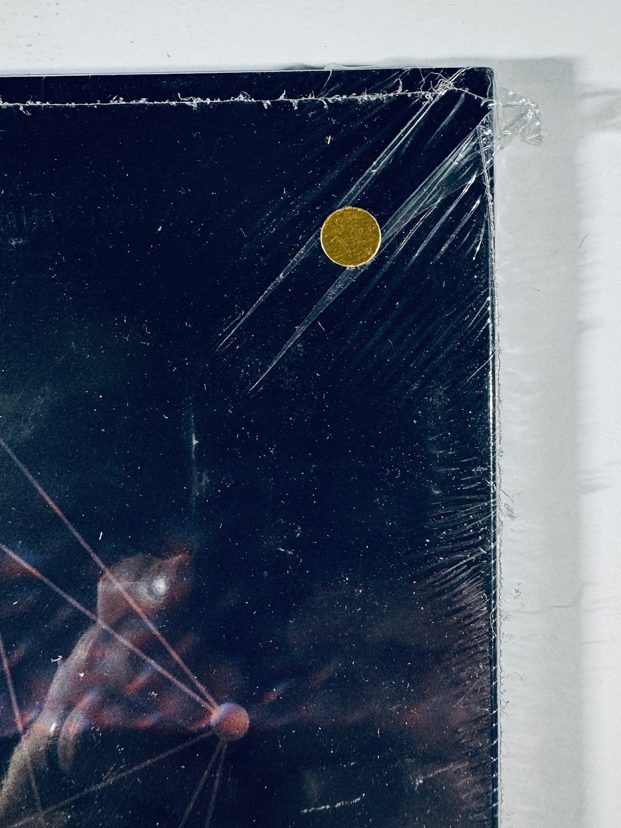 Close-up of the shrink wrap corner on the unofficial gold vinyl release of Tool's Fear Inoculum.