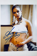 Signed full photo of Alicia Keys in a white crop top and beaded necklace, featuring a blue autograph.
