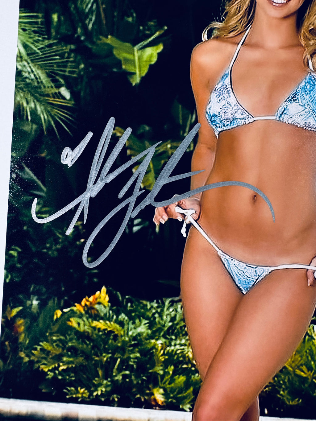 Close-up view of Amber Lancaster's silver signature across the front of the promotional photograph.