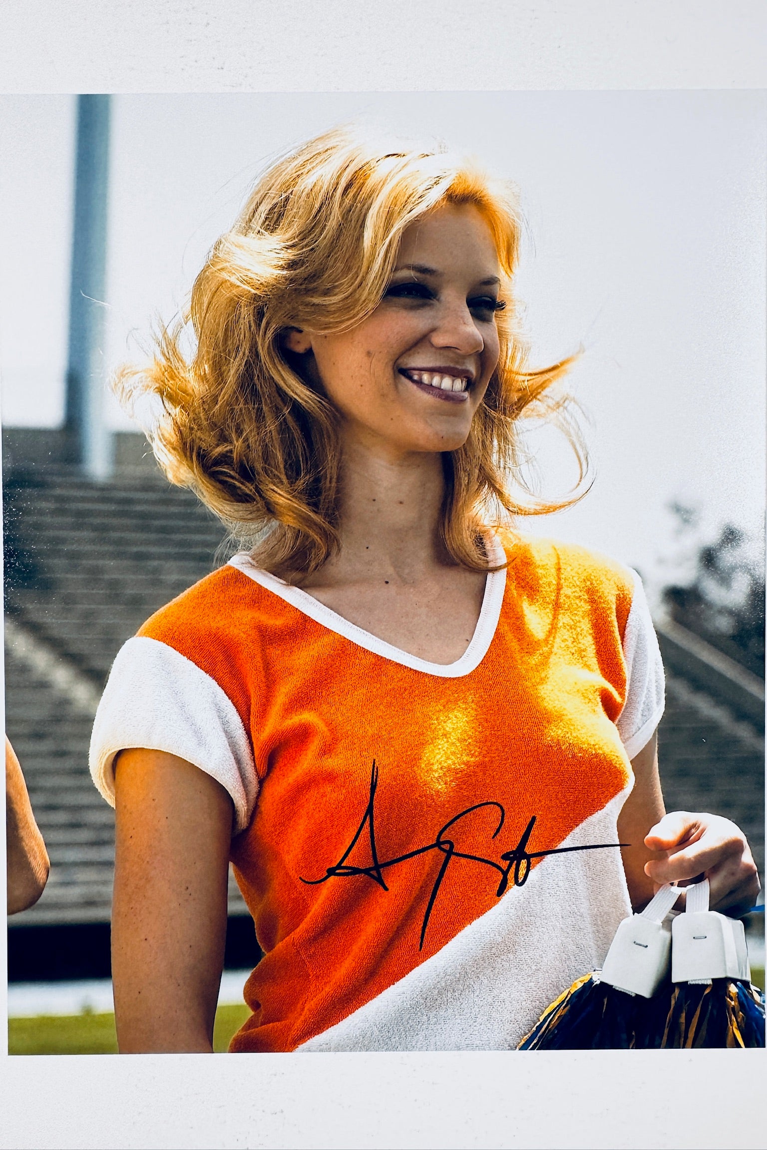 Signed 8x10 matte photo of actress Amy Smart from Starsky & Hutch posing in an orange and white cheerleader top, featuring a bold black ink autograph.