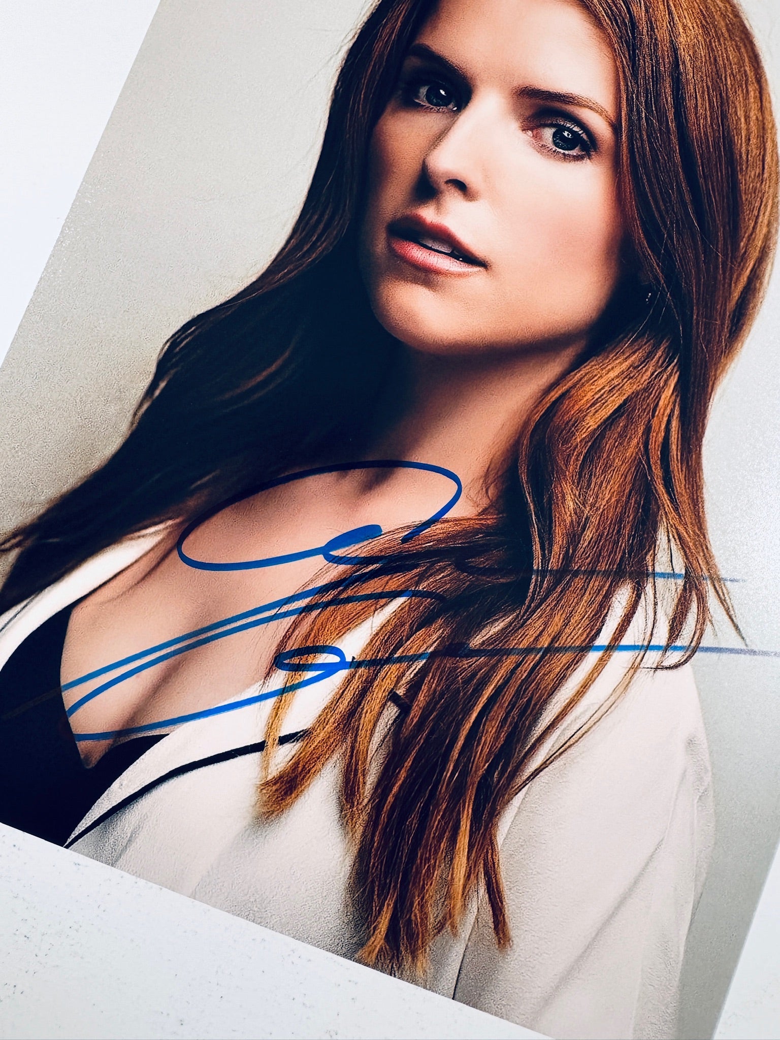 Close-up view of Anna Kendrick's signature in blue marker across the promotional matte photo.
