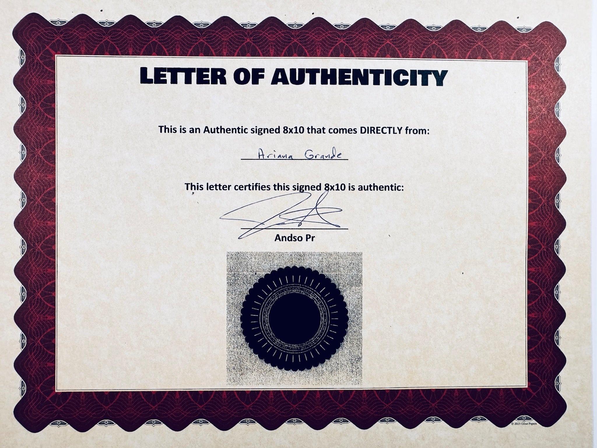 A Letter of Authenticity with a decorative burgundy-patterned border, certifying an authentic signed 8x10 coming directly from Ariana Grande, featuring a dark circular seal graphic at the bottom.