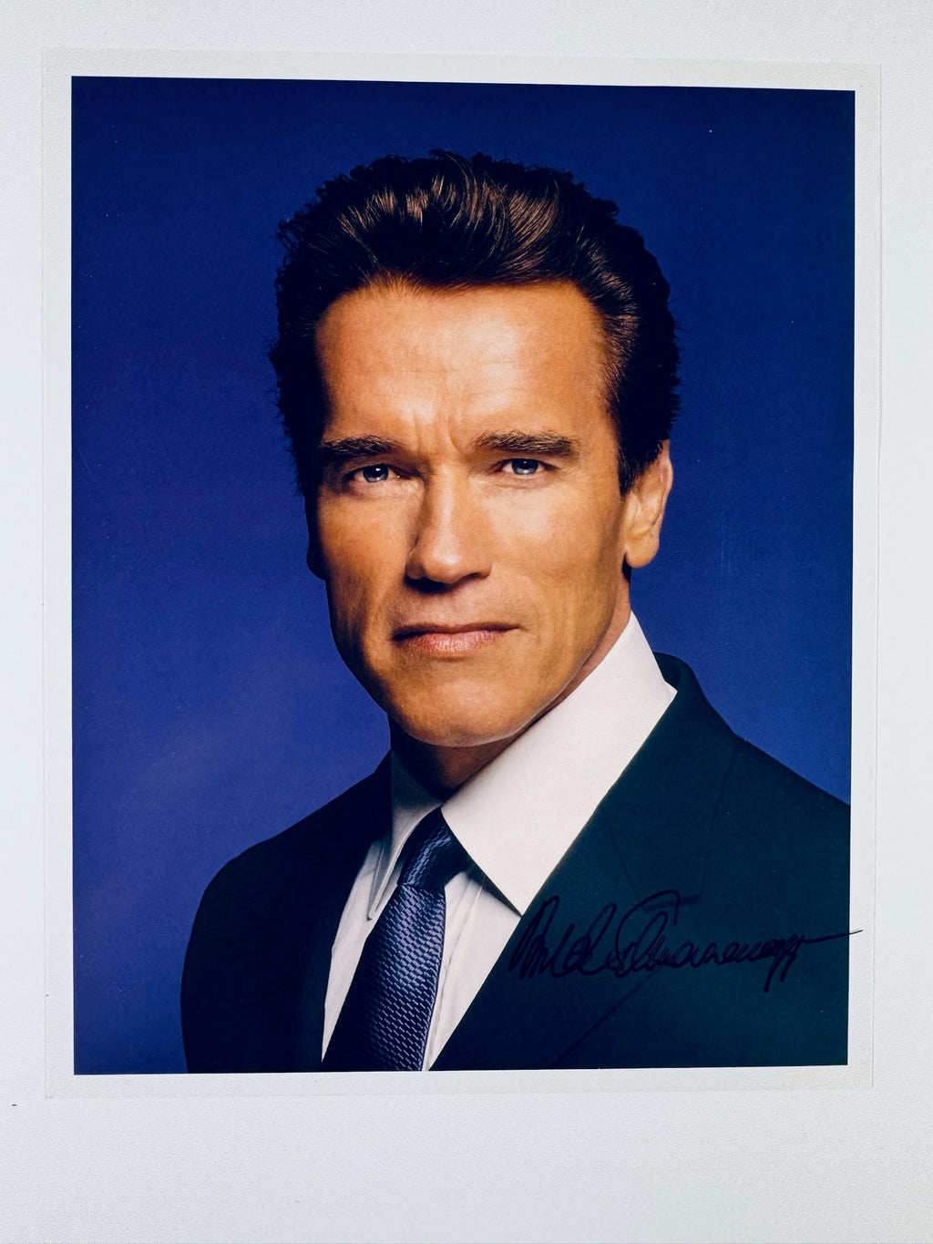 Autographed 8x10 color portrait photo of Arnold Schwarzenegger signed in black ink.