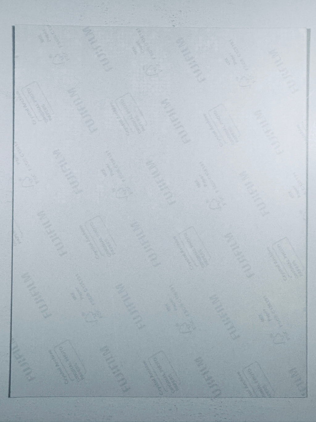 The plain white reverse side representing the back physical condition of the photograph print, showing translucent Fujifilm crystal archive paper watermarks and logos.