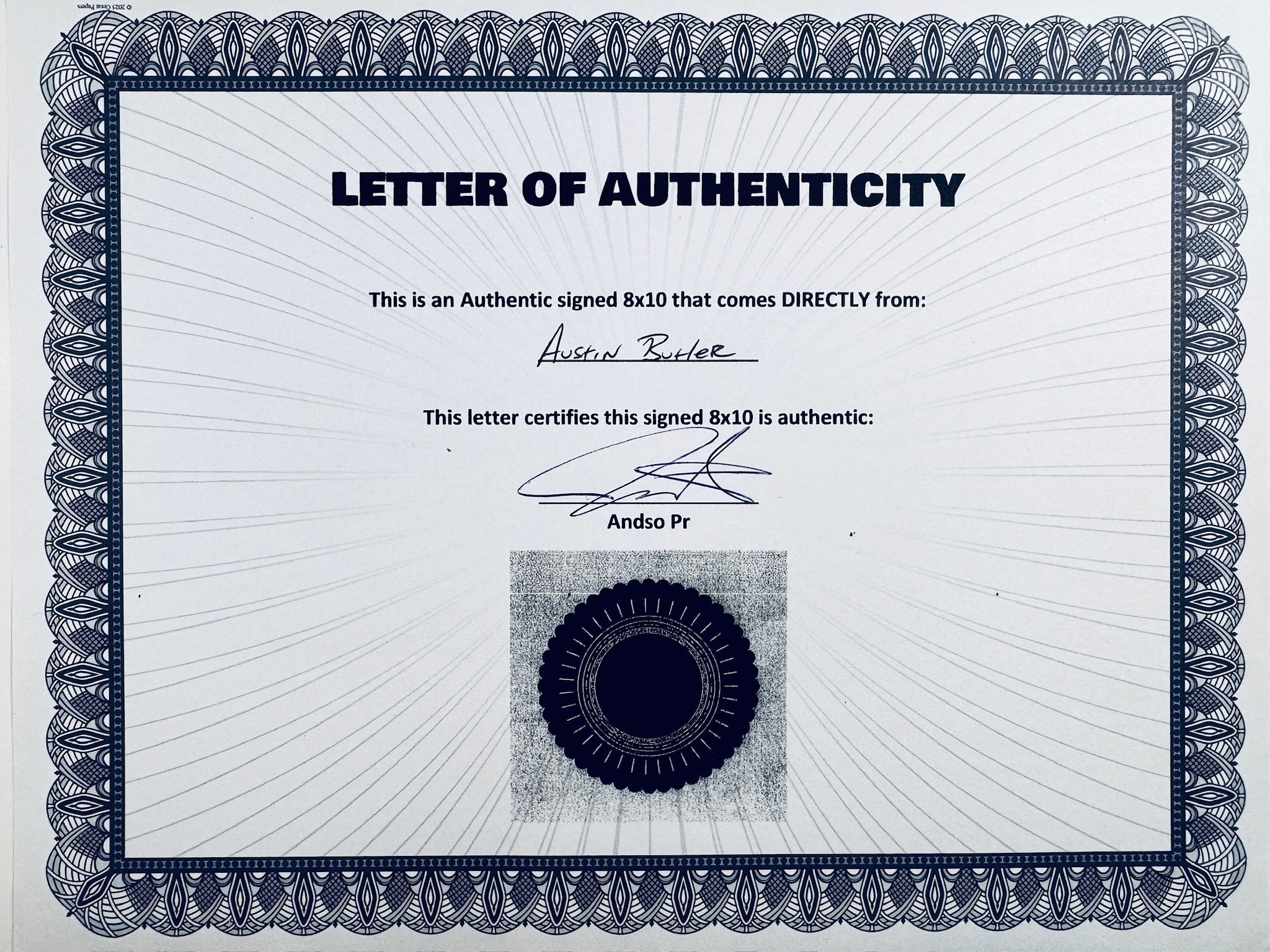 A Letter of Authenticity with a decorative blue-patterned border, certifying an authentic signed 8x10 coming directly from Austin Butler, featuring a dark circular seal graphic at the bottom.