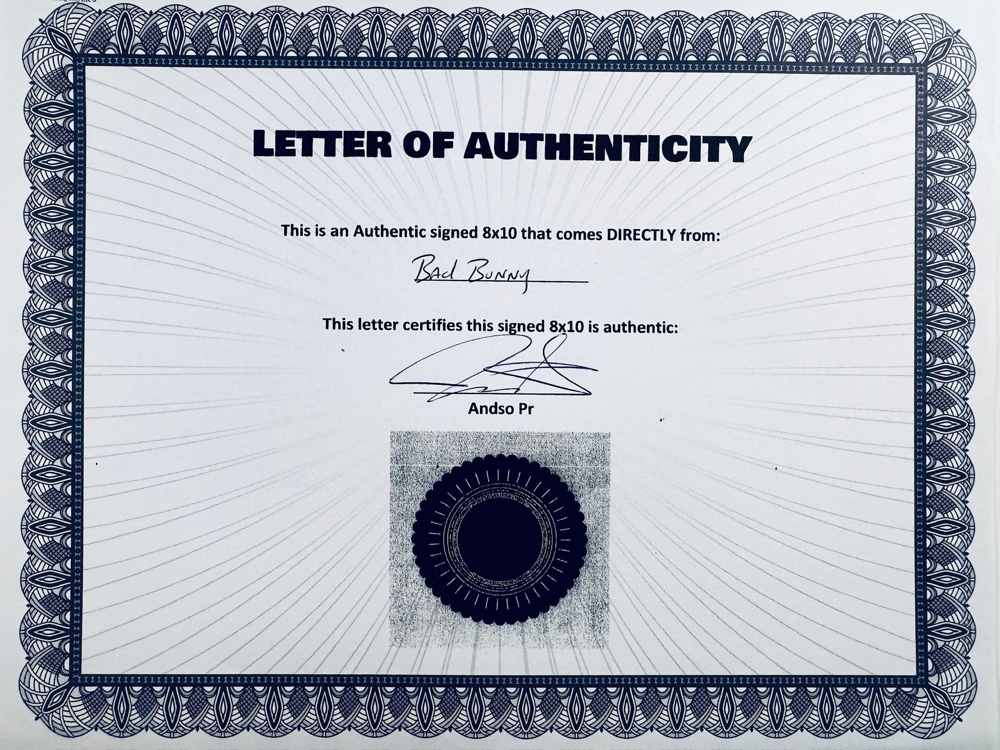 A Letter of Authenticity with a decorative blue-patterned border, certifying an authentic signed 8x10 coming directly from Bad Bunny, featuring a signature and a dark circular seal graphic at the bottom.