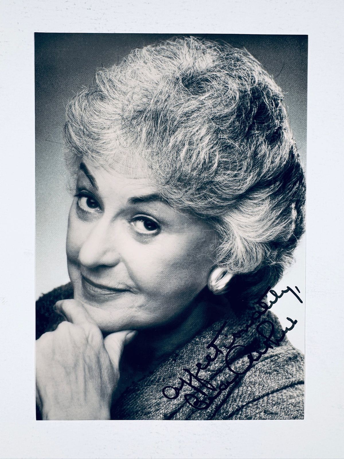 Black and white vintage publicity headshot portrait of actress Bea Arthur smiling with her hand resting under her chin, featuring an authentic signature reading "Affectionately, Bea Arthur" across the bottom right corner.