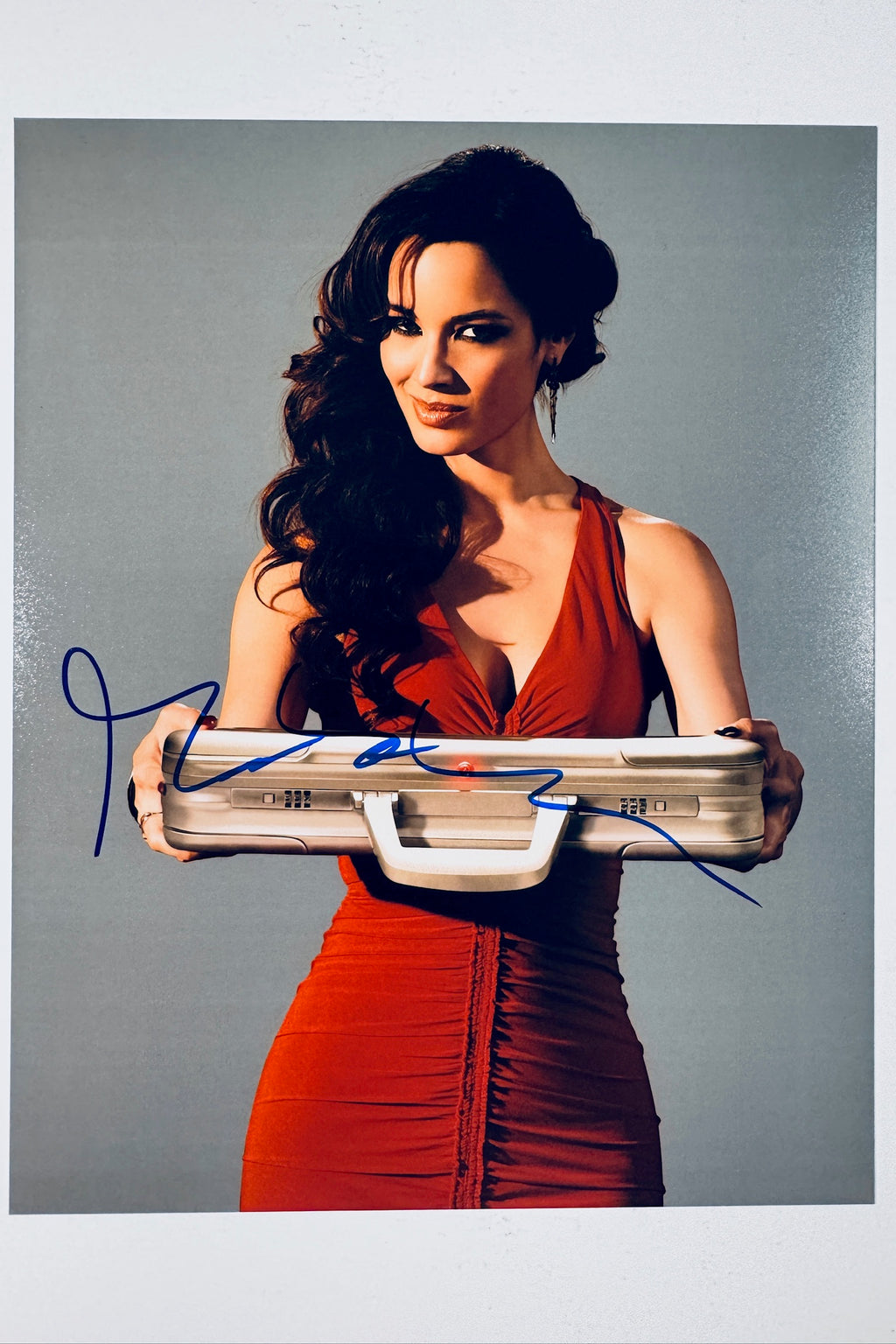 Signed full photo of Bernice Marlohe, a James Bond girl as Sévérine from the film Skyfall, featuring a blue autograph.