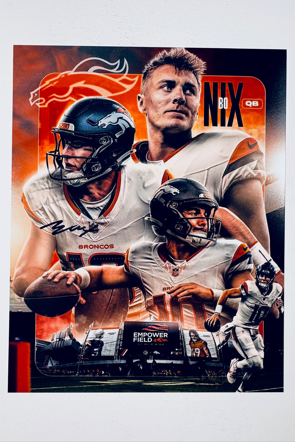 Signed full photo of Bo Nix as quarterback for the Denver Broncos, featuring a black autograph on his jersey.