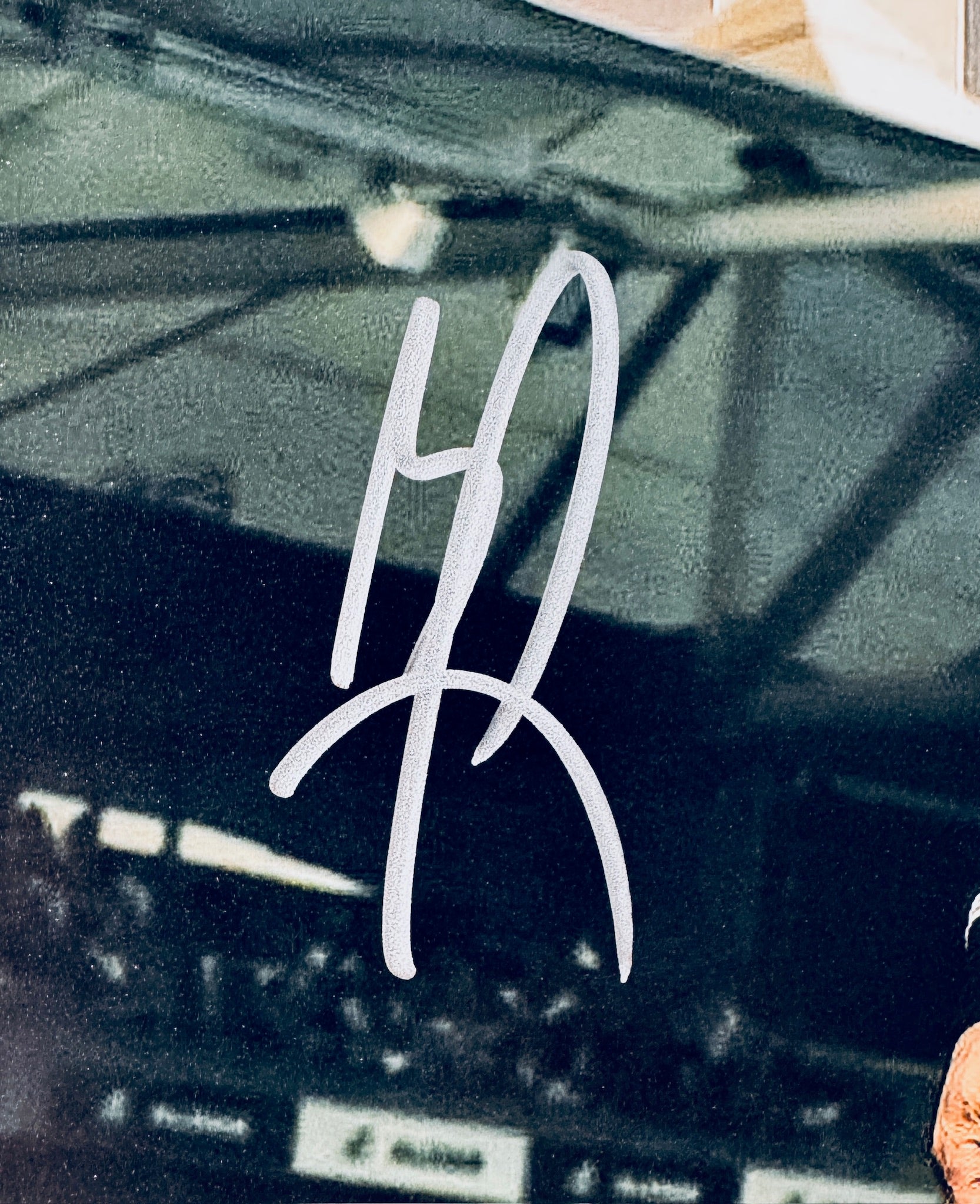 Close-up of Brad Pitt's signature in silver marker on the signed F1 The Movie 8x10 photo.
