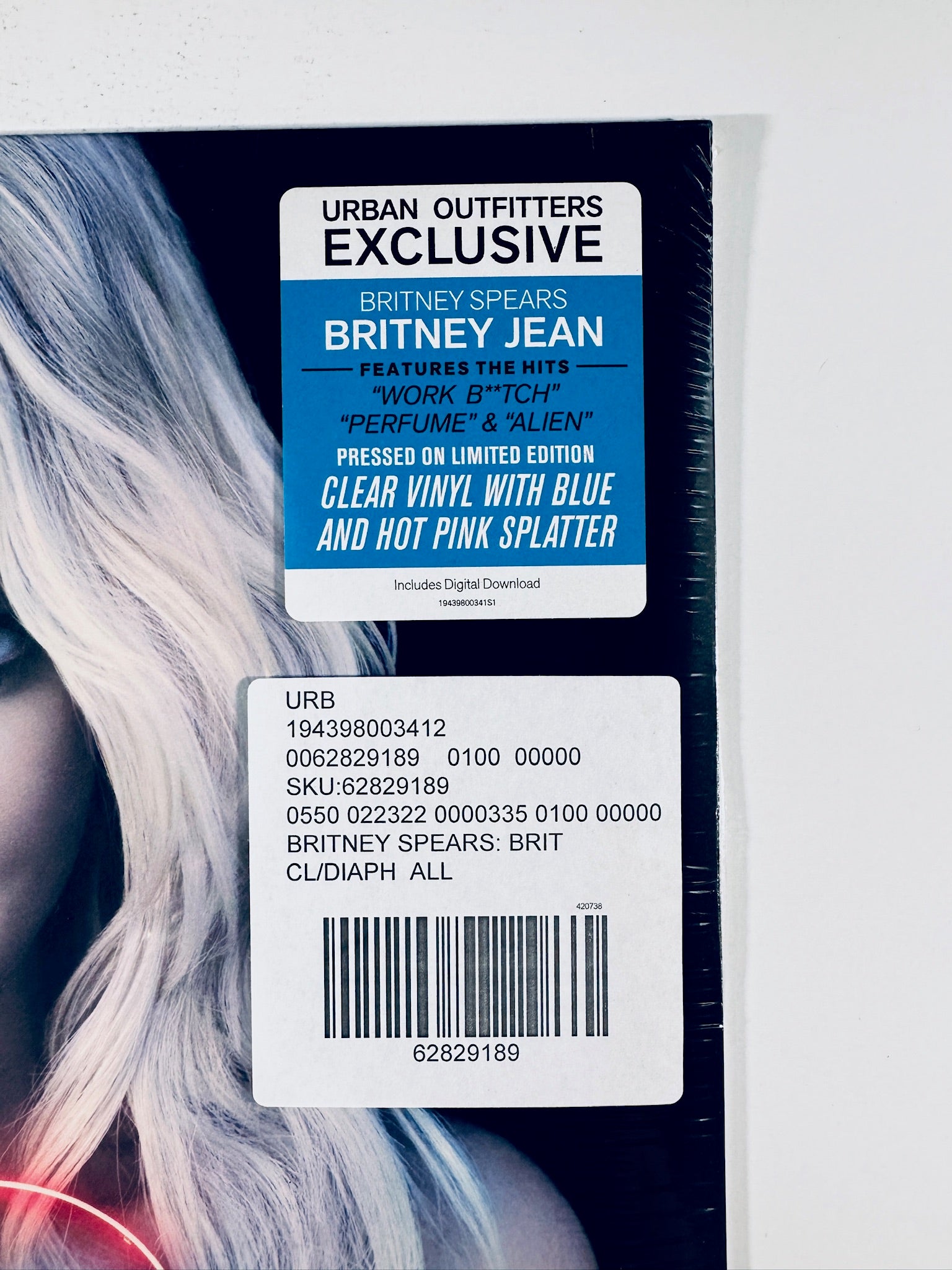 Close-up of the Urban Outfitters exclusive hype sticker and store inventory barcode tag on the front cover of the Britney Spears Britney Jean vinyl record.