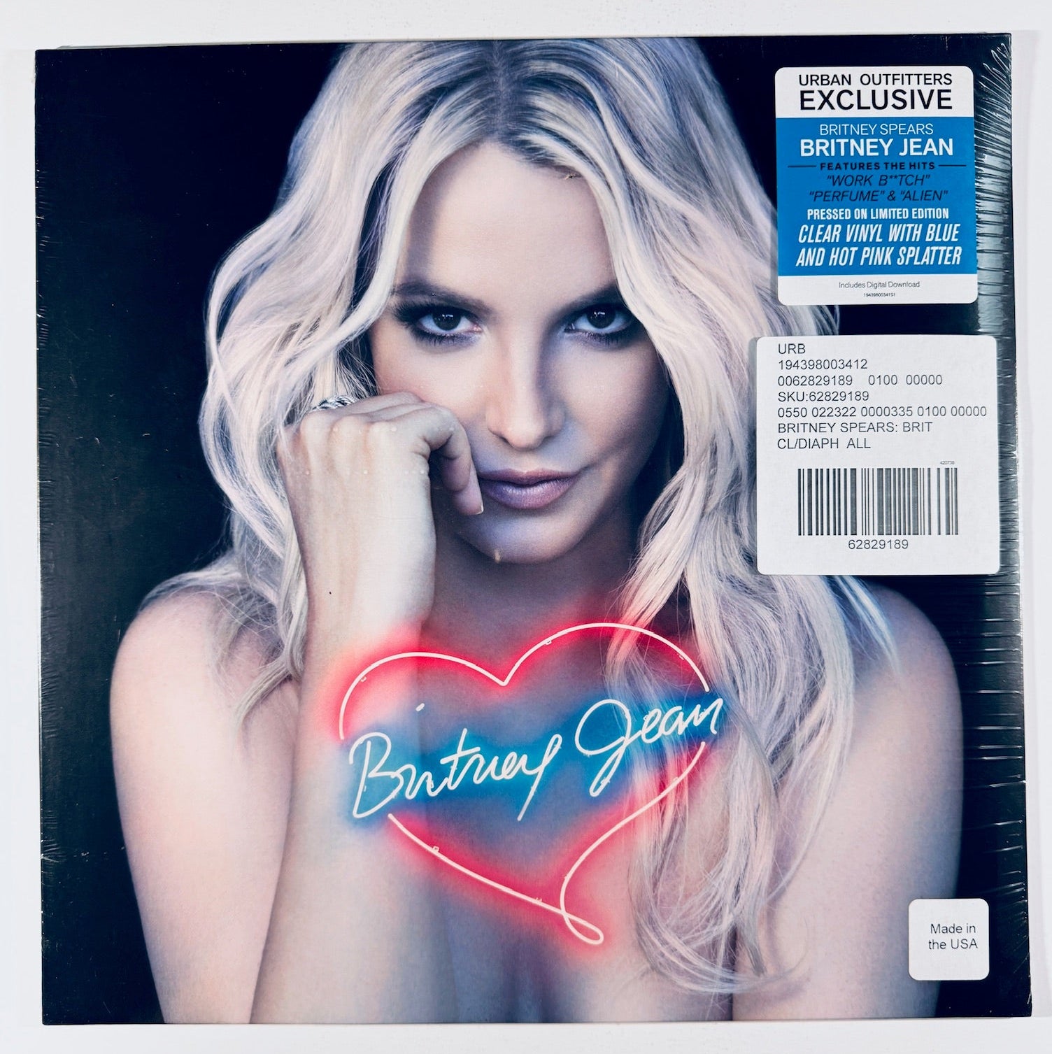 Front cover of the Britney Spears Britney Jean Urban Outfitters Exclusive clear vinyl LP with blue and hot pink splatter, featuring the hype sticker and barcode tag.