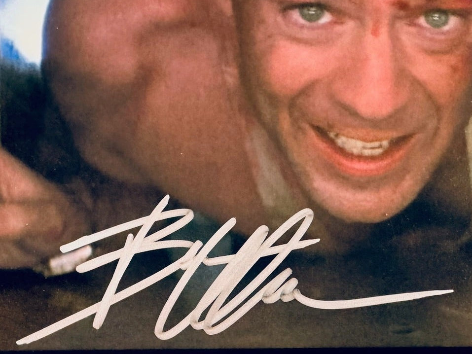 Closeup of Bruce Willis autograph on Die Hard signed 10x8 photo