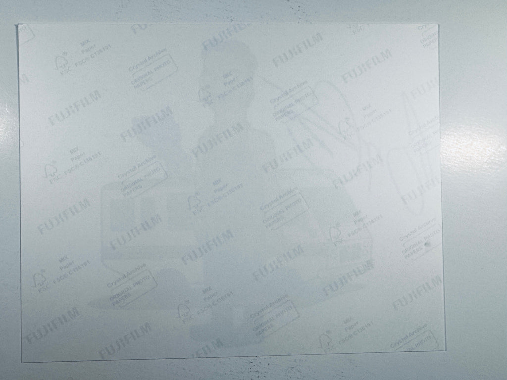 The plain white reverse side representing the back physical condition of the photograph print, showing translucent Fujifilm crystal archive paper watermarks and logos.