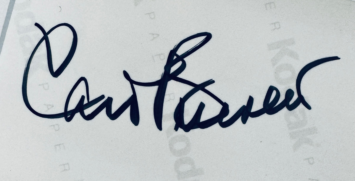 Close-up view of Carol Burnett autograph in black sharpie on the back of Kodak paper.