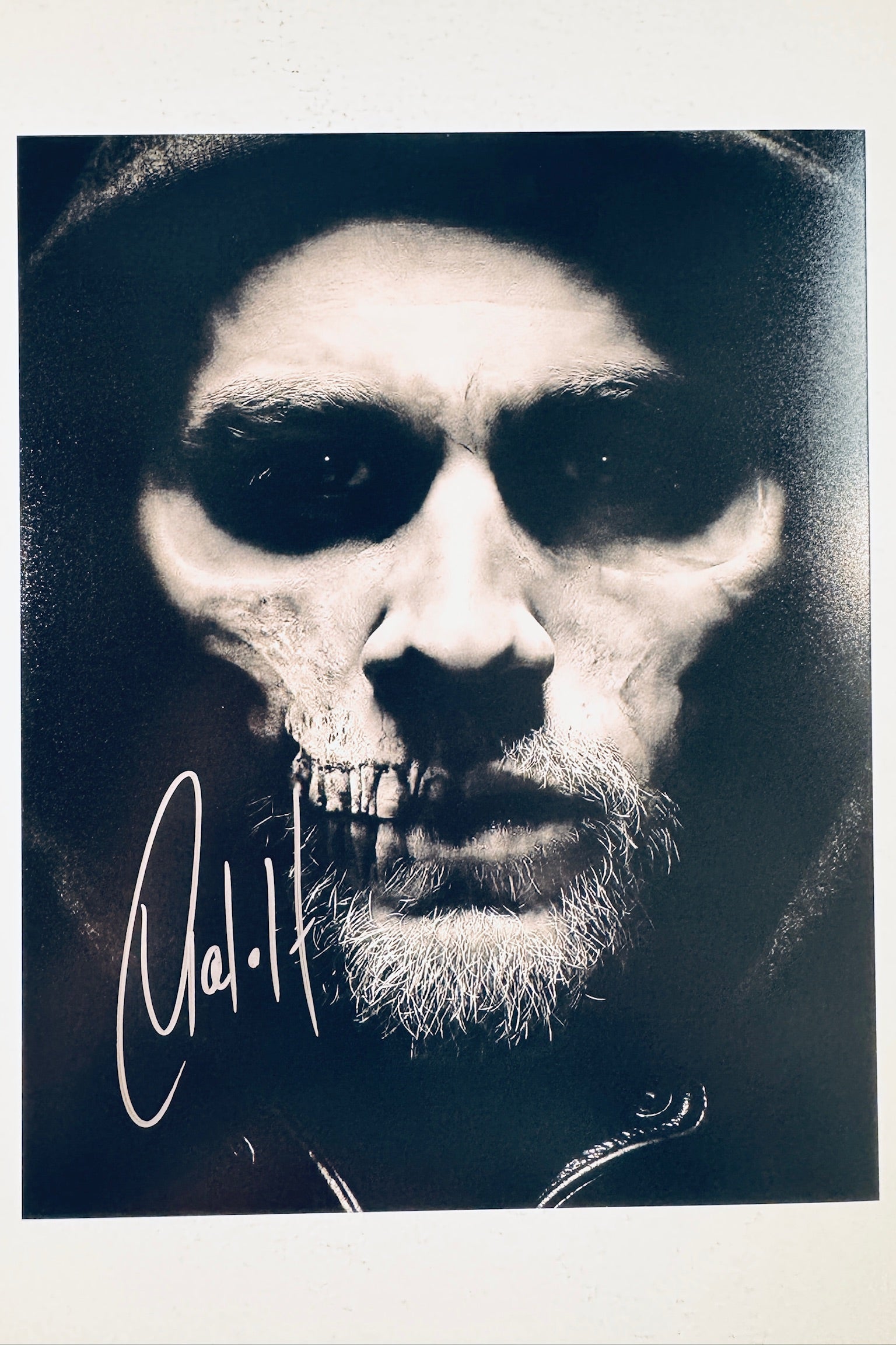 Signed full photo of Charlie Hunnam as Jax Teller from Sons of Anarchy with a skull face makeup effect, featuring a silver autograph.