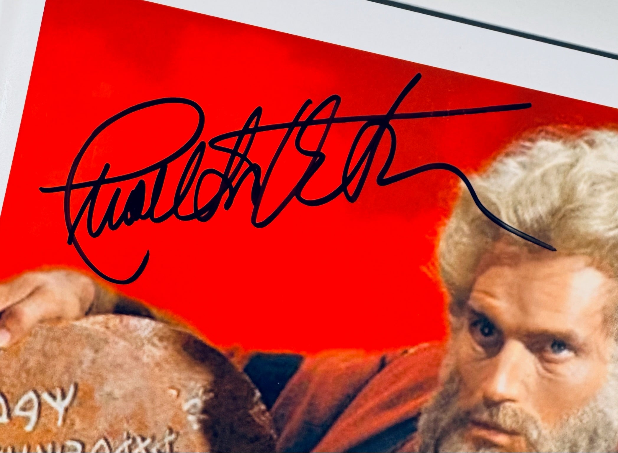 Closeup of Charlton Heston autograph on The Ten Commandments signed 10x8 photo