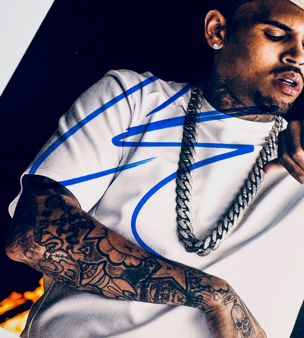 Close-up of Chris Brown's signature in blue marker on the signed 8x10 photo.