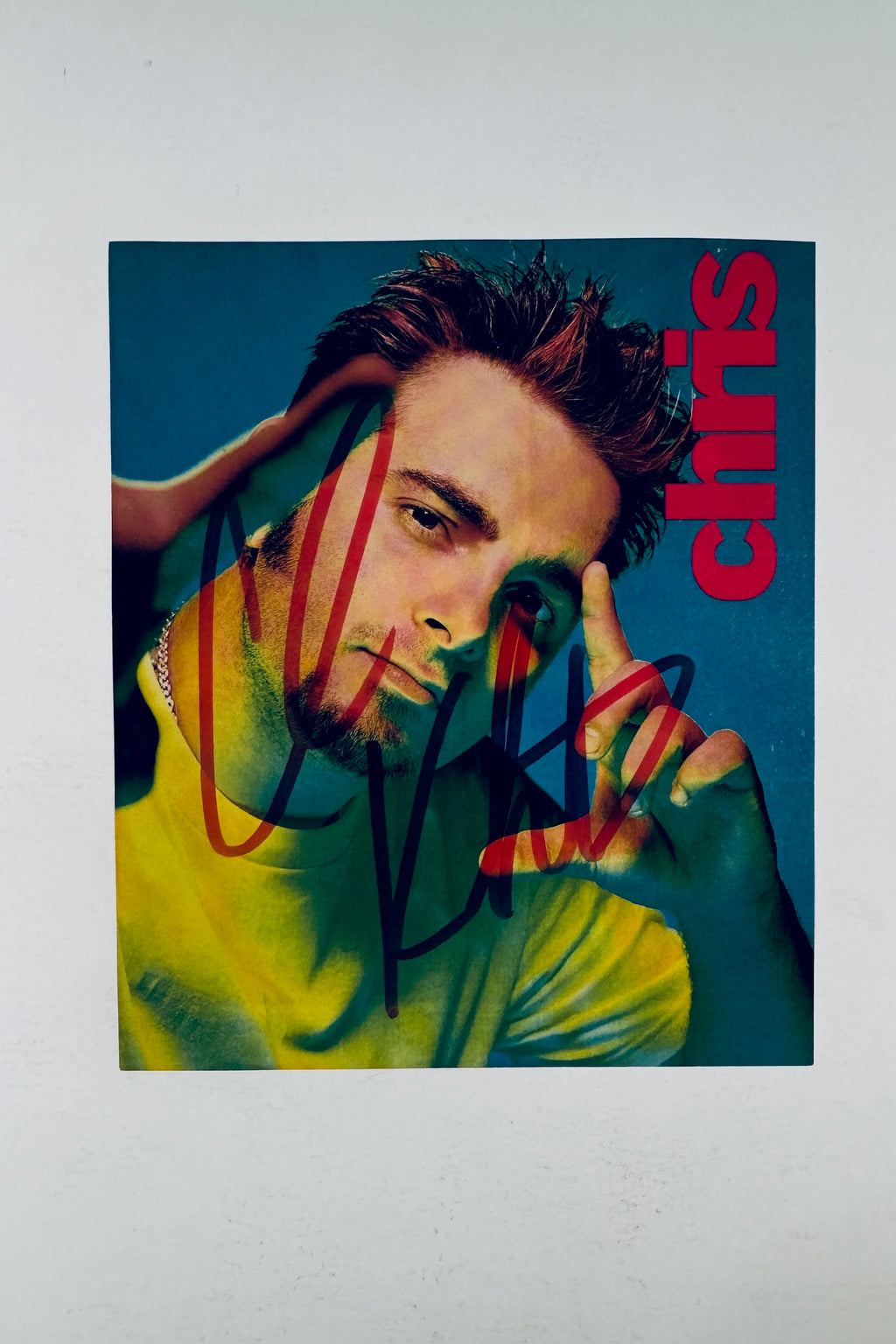 Full front view of magazine page photo hand-signed by Chris Kirkpatrick in black marker.