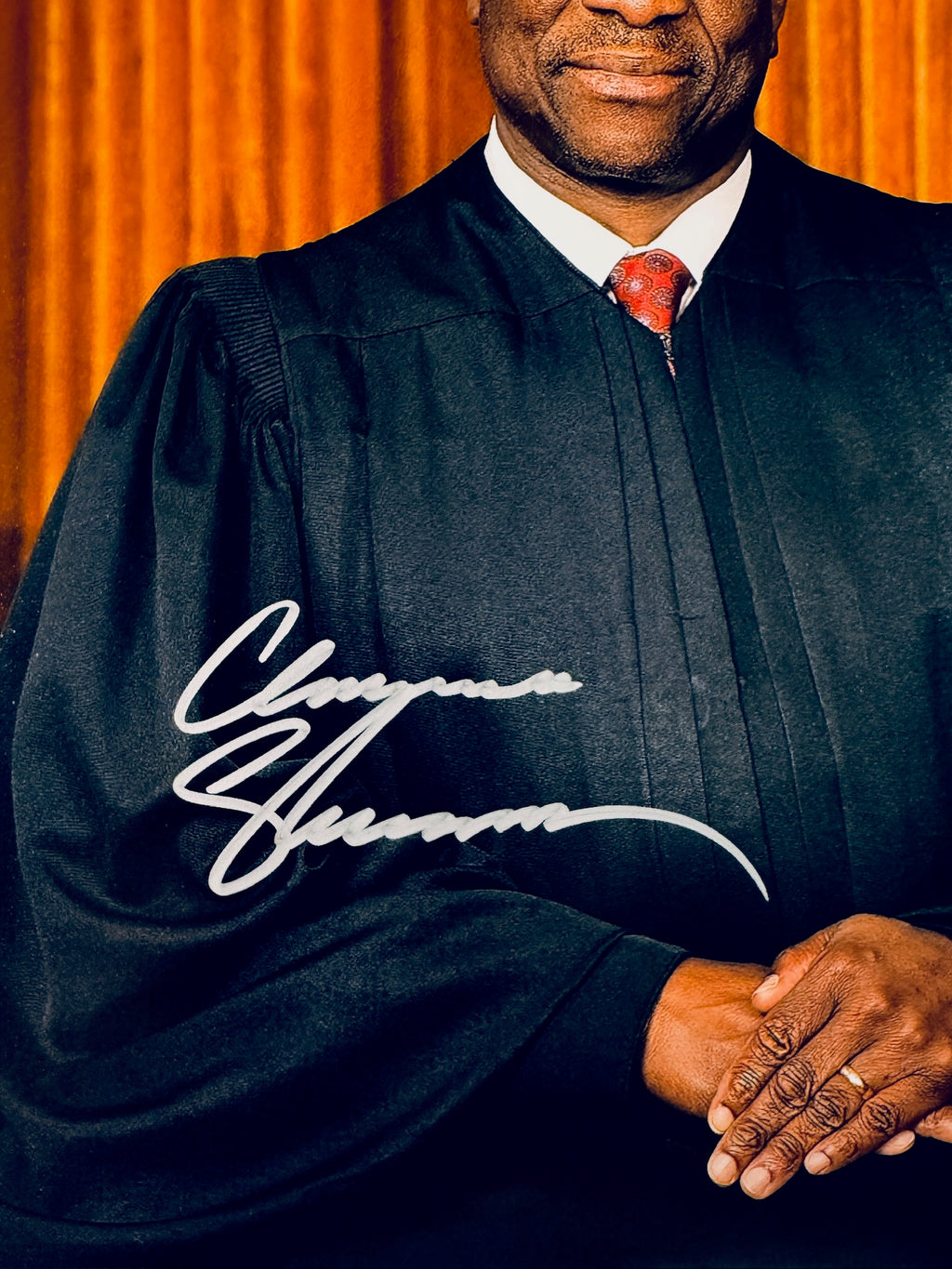 Close-up of Clarence Thomas's signature in silver marker on the signed Supreme Court 8x10 photo.
