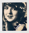 Square-cut vintage black and white movie magazine portrait clipping of Colleen Moore with an authentic hand-signed fountain pen autograph, isolated on a white background.