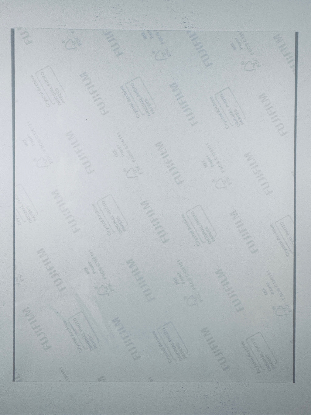 The plain white reverse side representing the back physical condition of the photograph print, showing translucent Fujifilm crystal archive paper watermarks and logos.