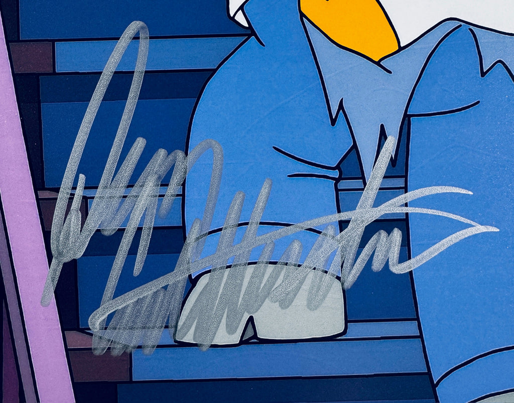 Close-up of Dan Castellaneta signature in silver marker on the Homer Simpson signed 8x10 photo.