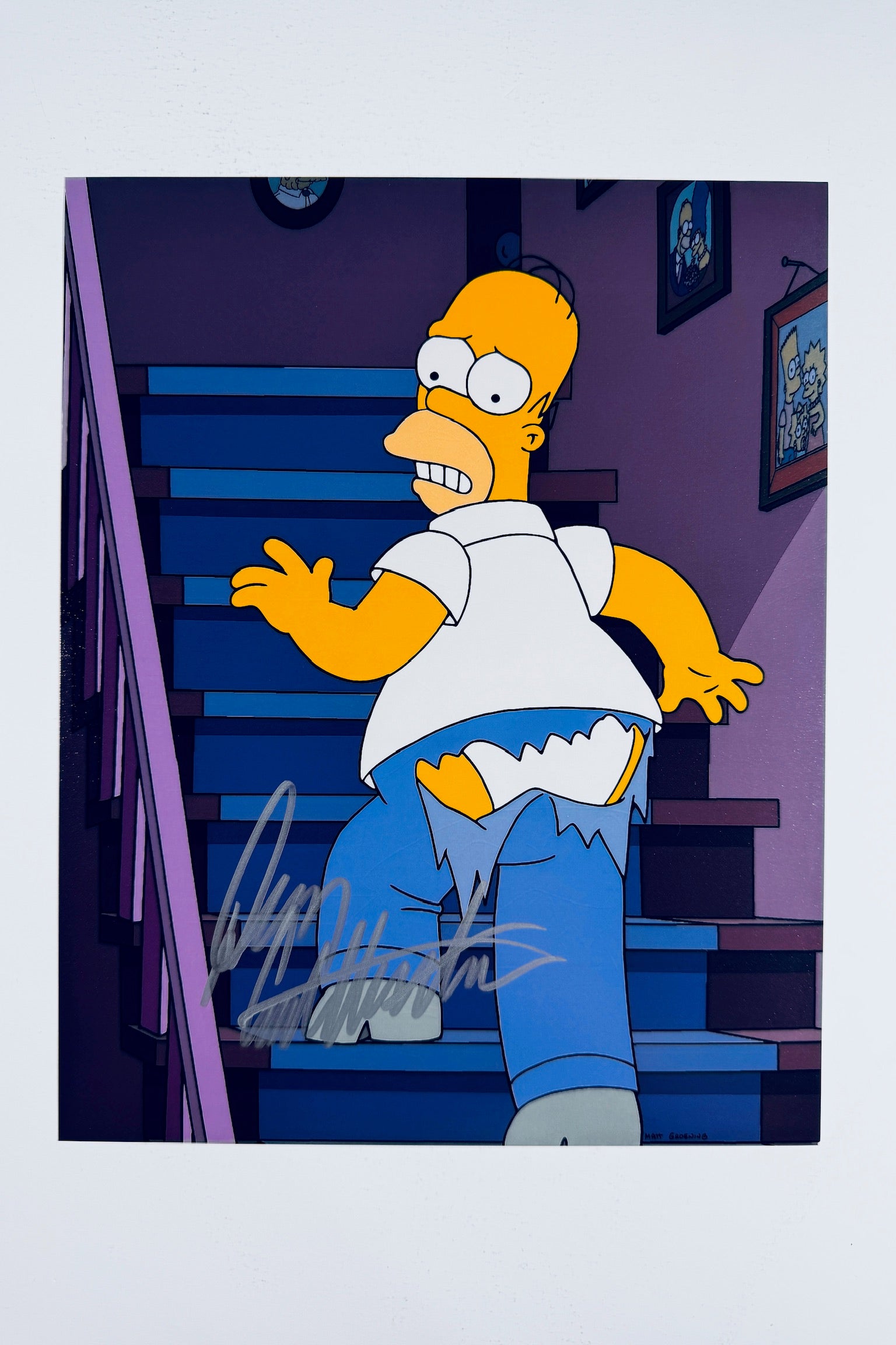 Dan Castellaneta hand-signed 8x10 matte photo featuring Homer Simpson walking upstairs with torn pants.