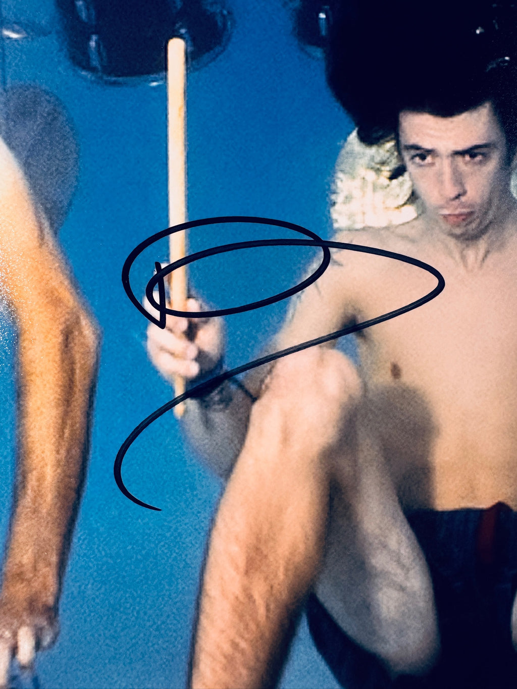 Close-up of Dave Grohl's signature in black marker on the signed Nirvana 8x10 photo.