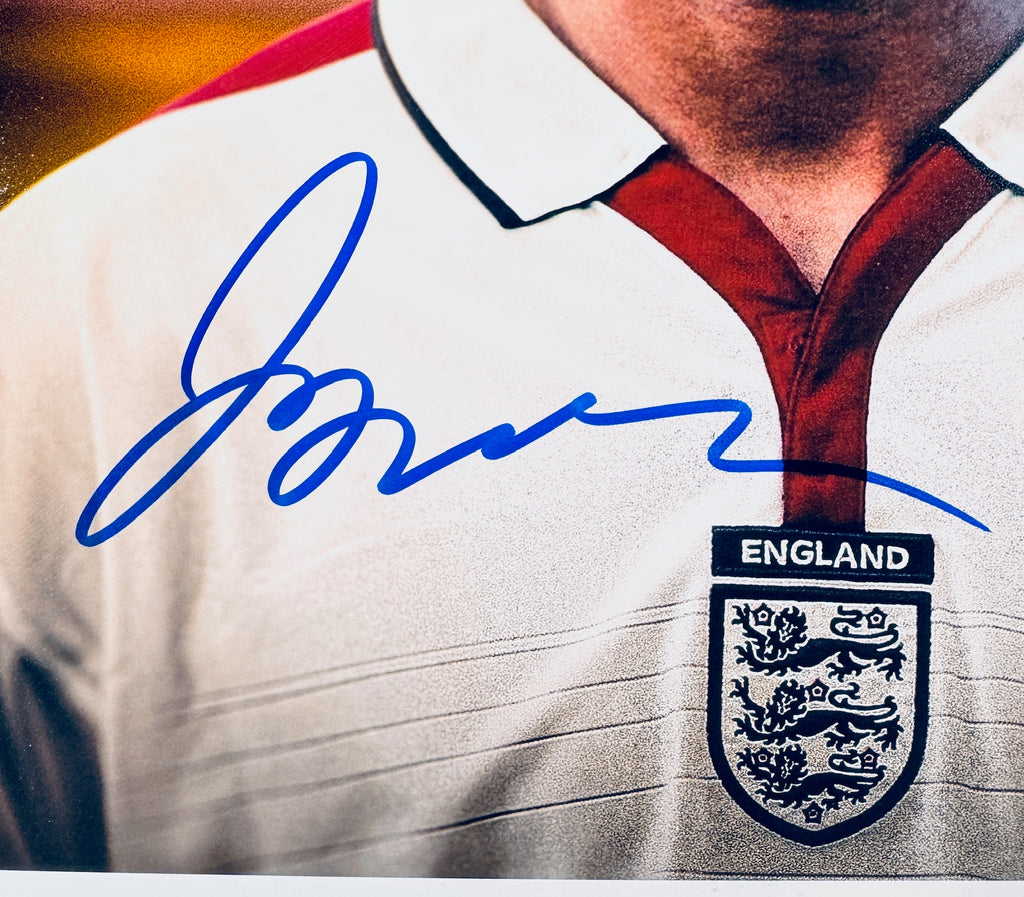 Close-up of David Beckham's signature in blue marker on the signed England 8x10 photo.