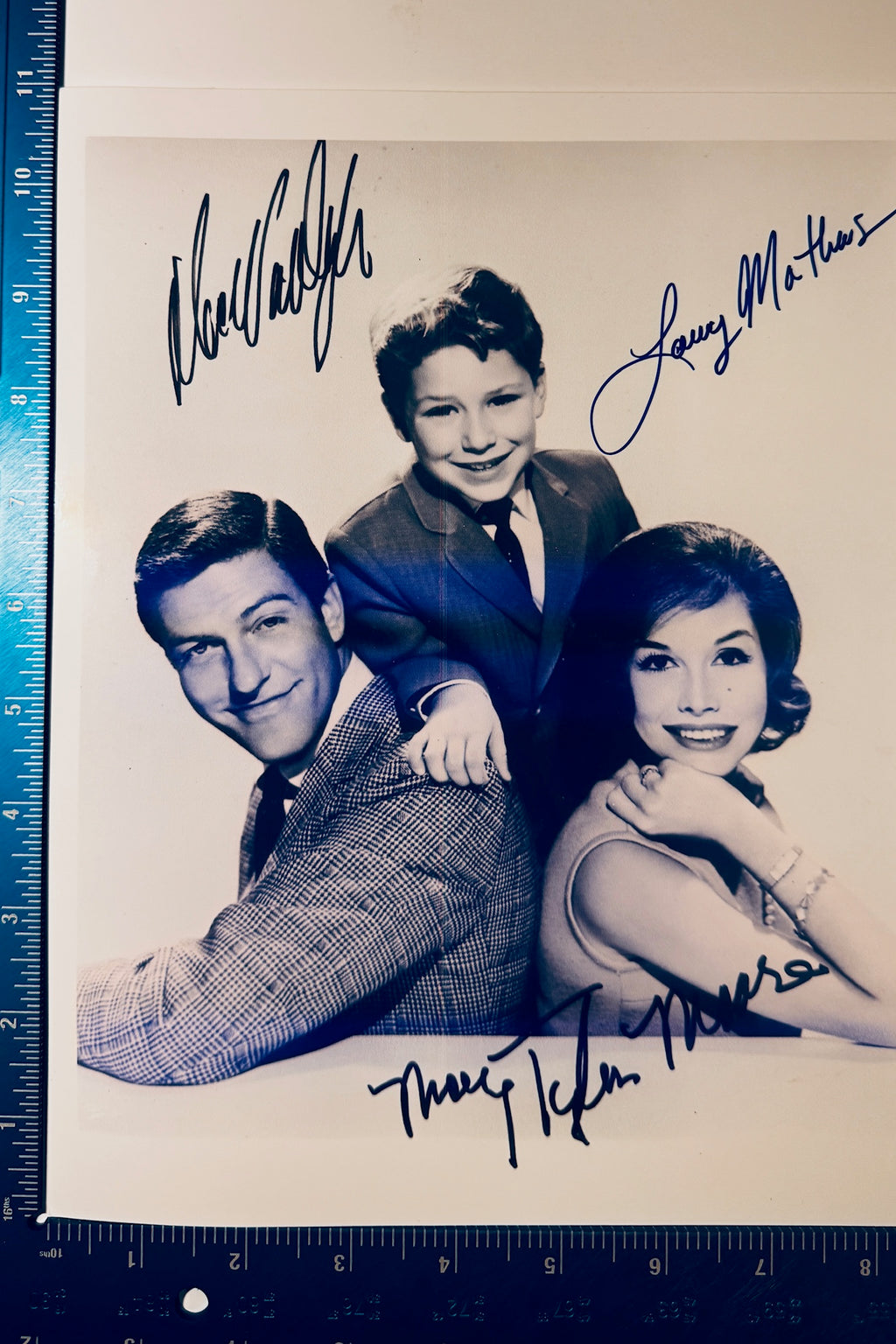 Vintage Dick Van Dyke Show cast autographed 8x10 photo shown next to a blue ruler measuring 8 by 10 inches.