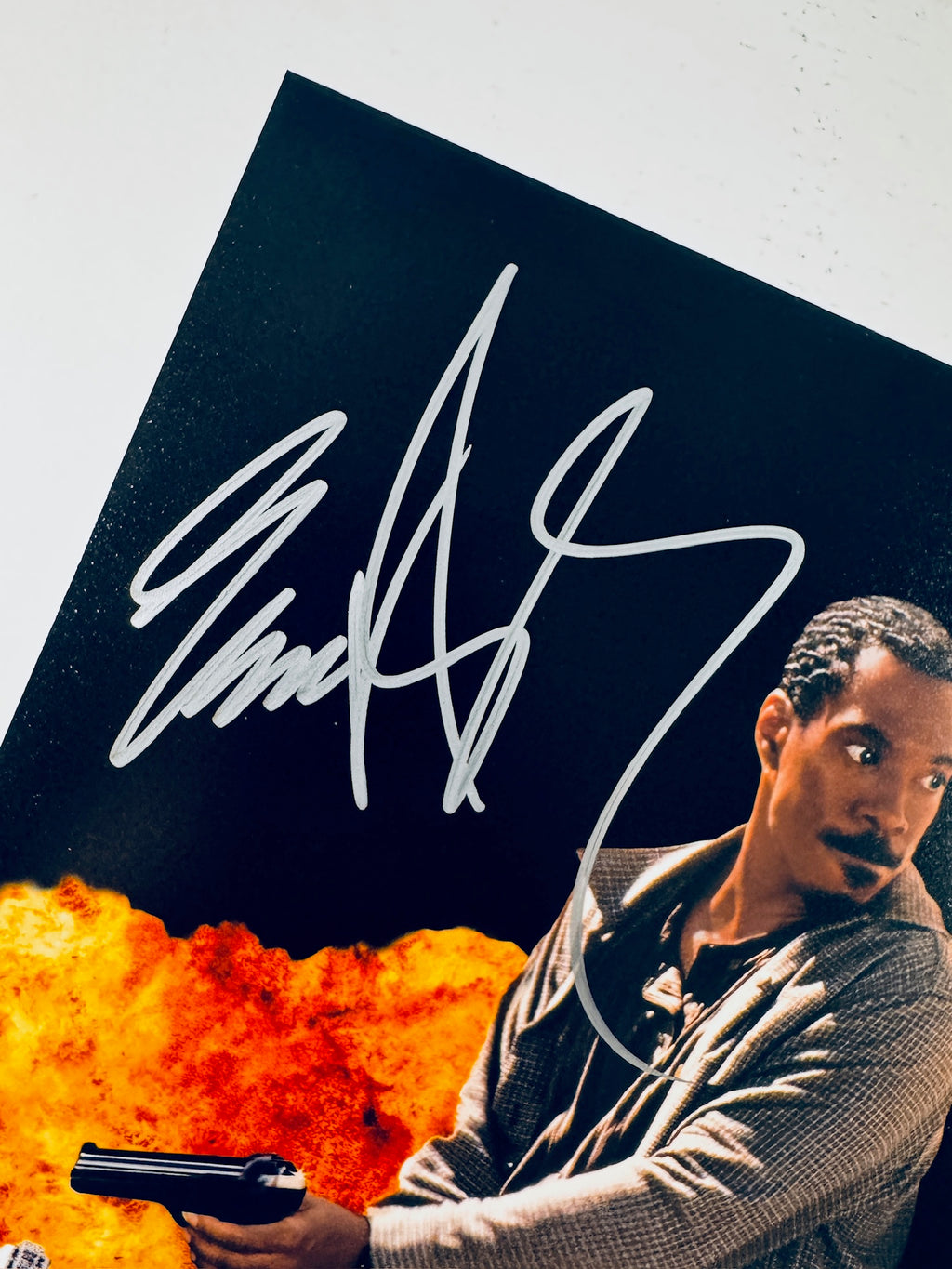 Close-up of Eddie Murphy's signature in silver marker on the signed Metro action 8x10 photo.