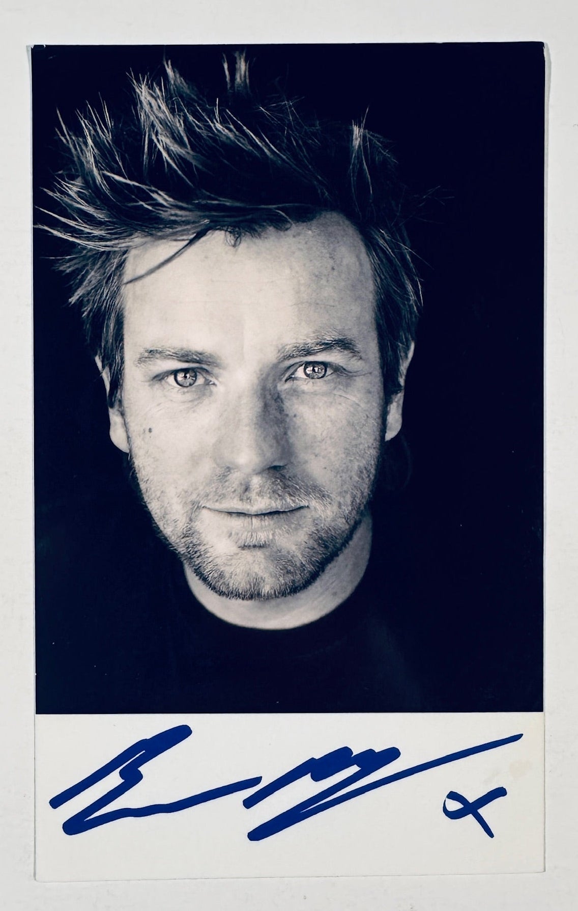 Full front view of black and white Ewan McGregor portrait photo hand-signed in blue marker.