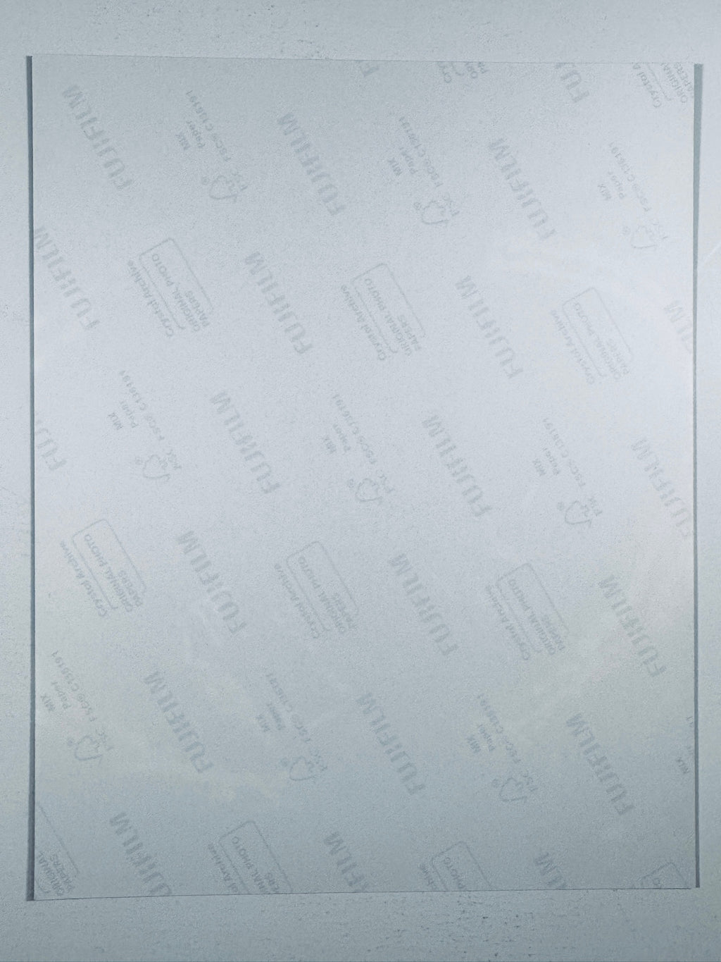 The plain white reverse side representing the back physical condition of the photograph print, showing translucent Fujifilm crystal archive paper watermarks and logos.