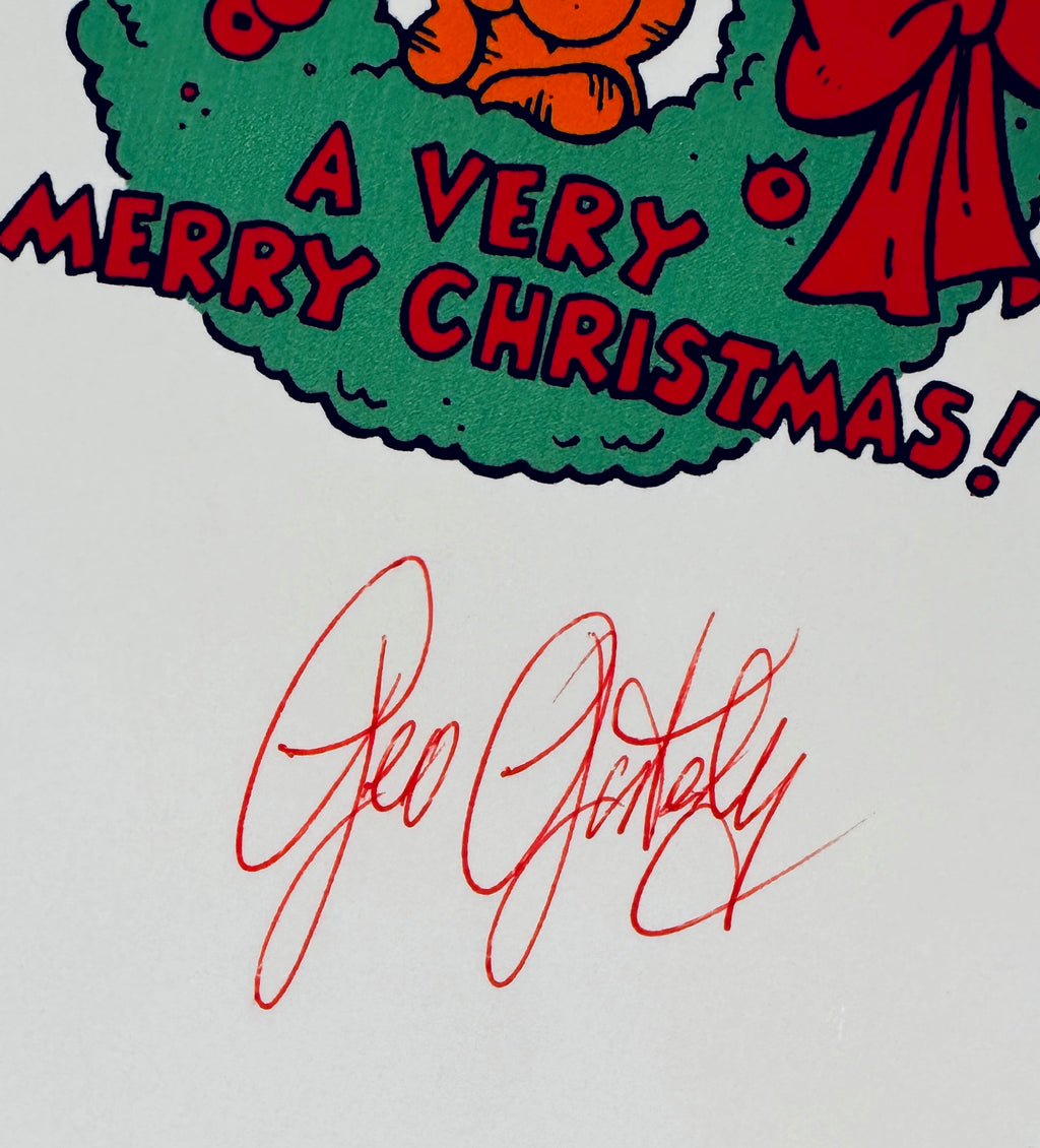 A close-up of a printed Christmas graphic with the text 'A VERY MERRY CHRISTMAS!' in red over a green wreath, plus a red cursive signature reading Geo Gottalky on a white background.
