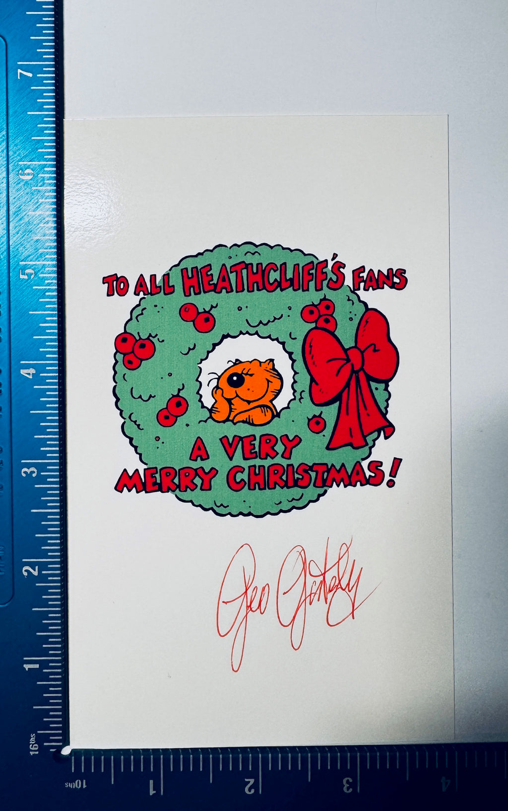 Geo Gately signed Heathcliff Christmas photo card shown with ruler measurements.
