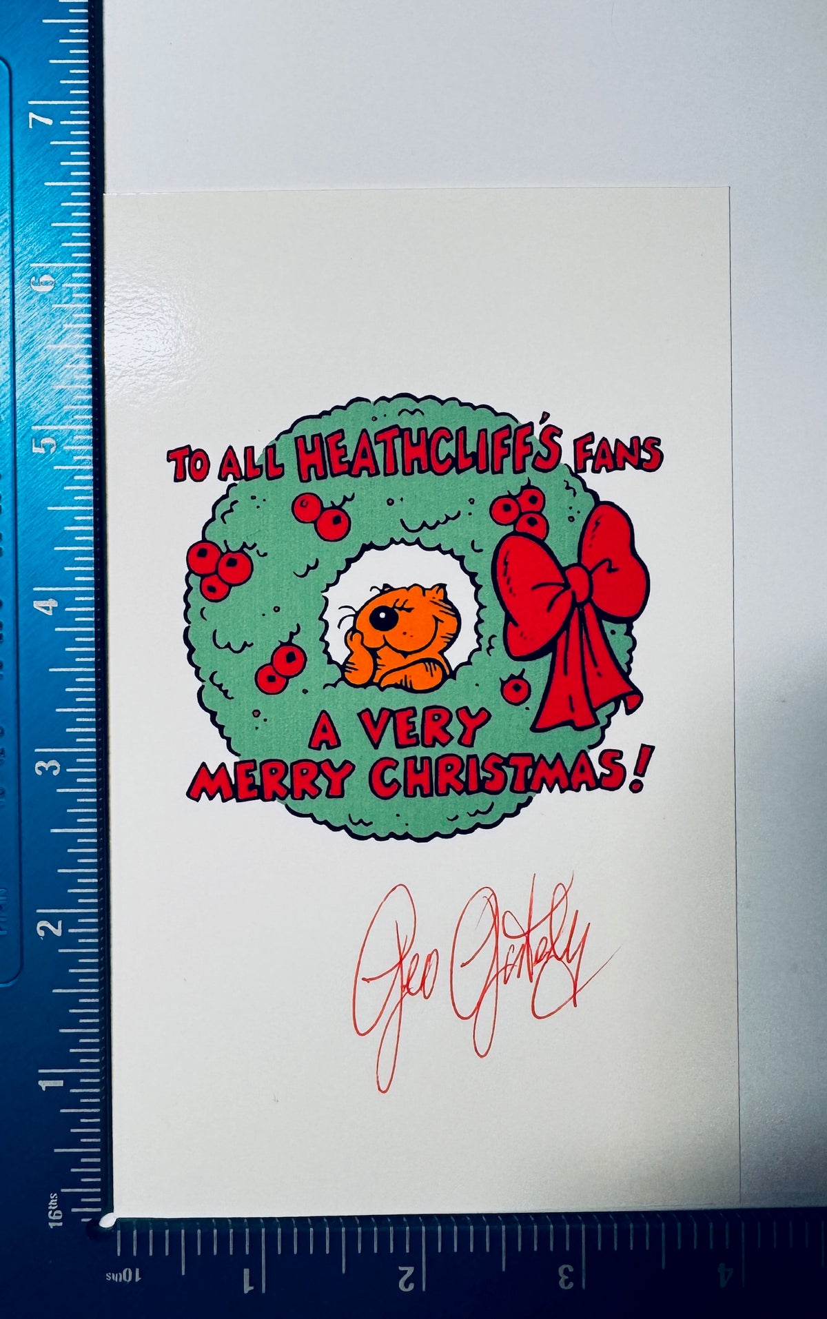 Geo Gately signed Heathcliff Christmas photo card shown with ruler measurements.