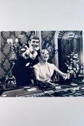 Signed 8x10 matte vintage black and white photo from On Her Majesty's Secret Service featuring George Lazenby and Diana Rigg at a casino table, with blue ink autographs by both actors.