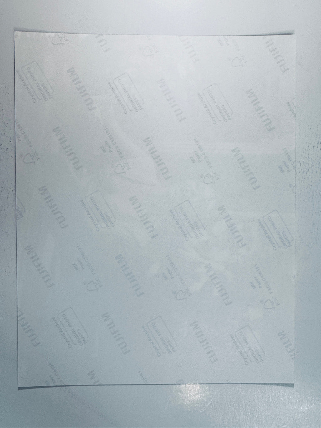 Fujifilm Crystal Archive photographic paper back surface showing the authentic backing and matte paper texture for the signed George Lazenby and Diana Rigg photo.