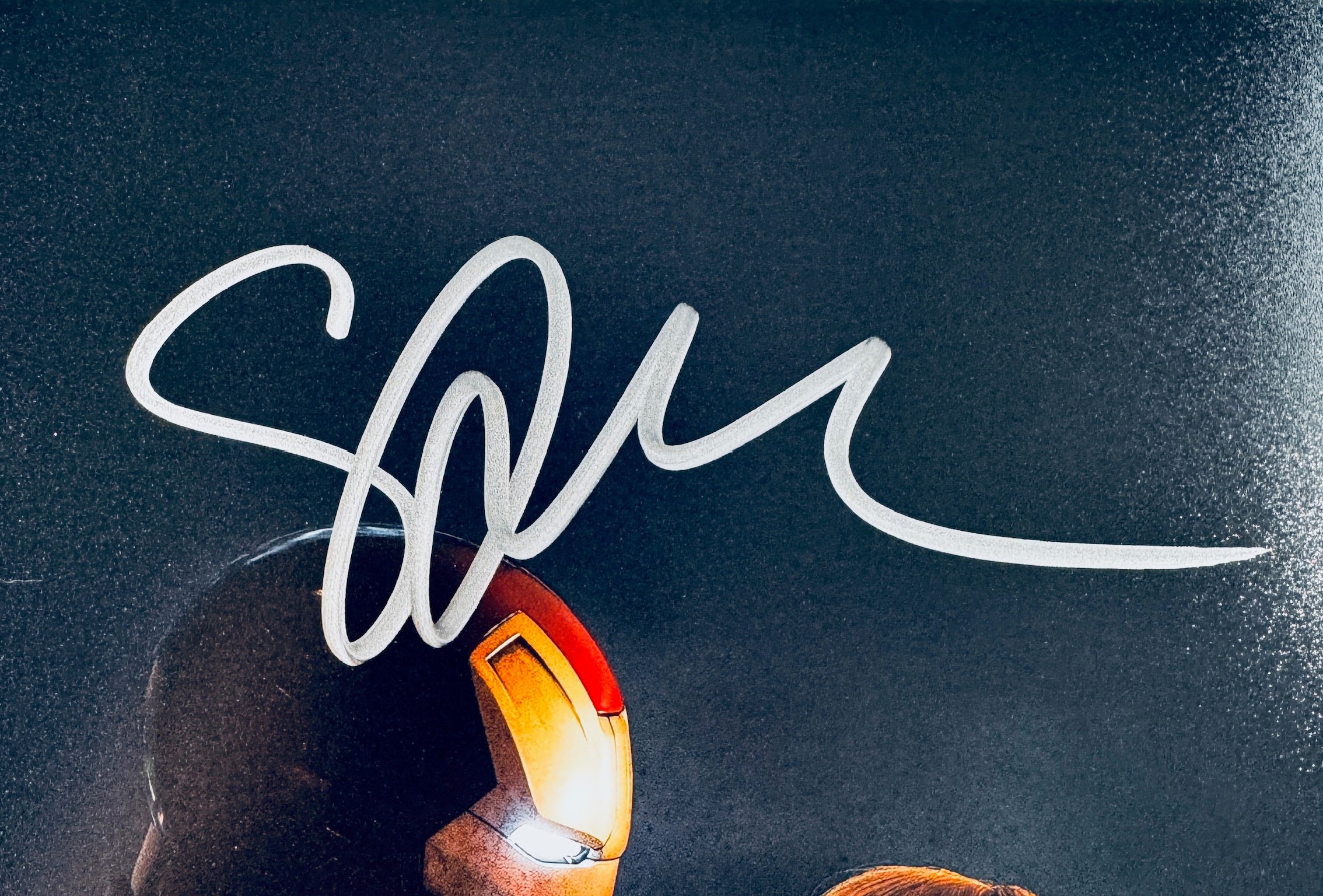 Close-up of Gwyneth Paltrow's signature in silver marker on the signed Iron Man 8x10 photo.
