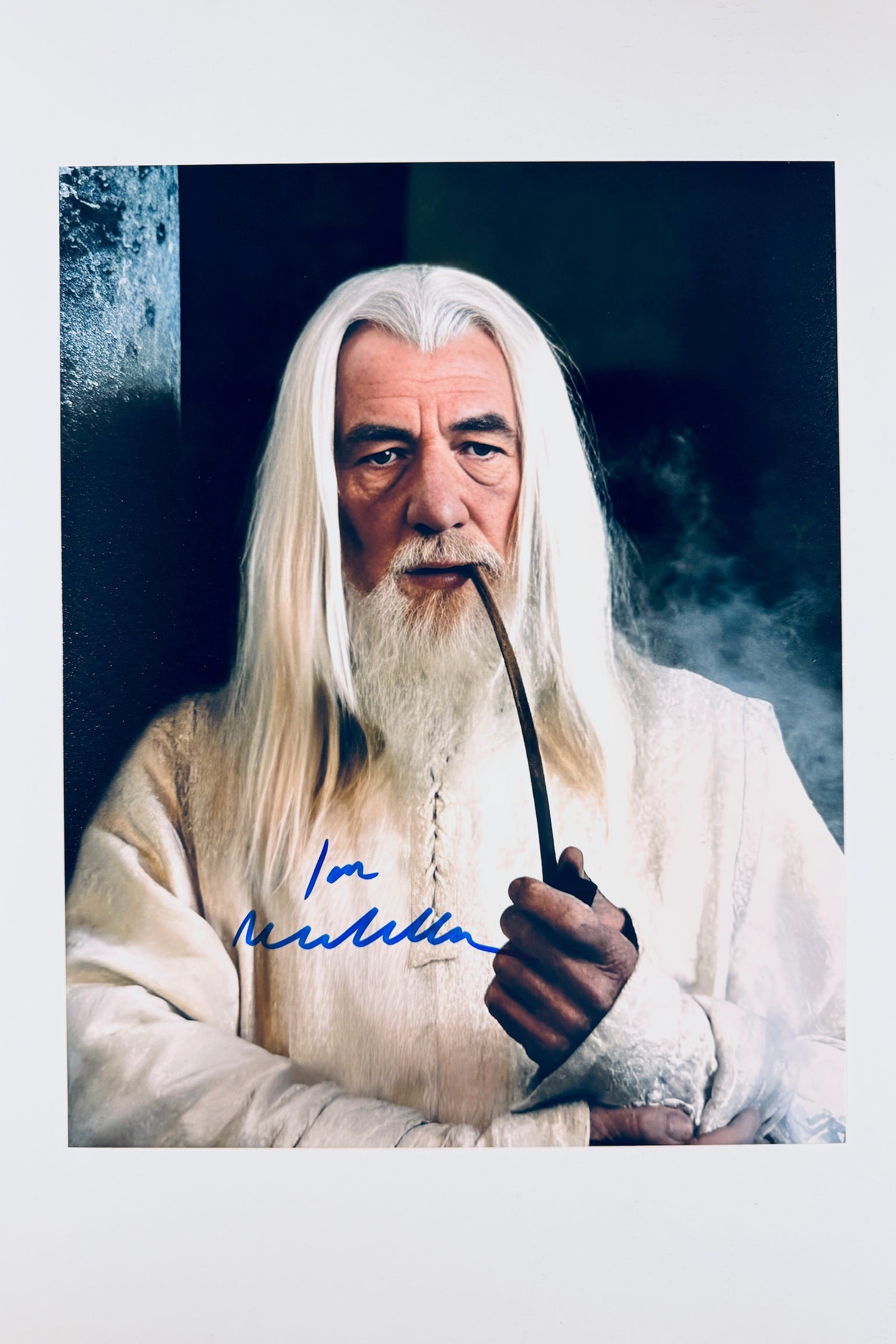 A still featuring Ian McKellen as Gandalf the White smoking a pipe.