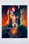 An autographed photo print of Ian Malcolm as Magneto from Marvel, signed in white ink across the lower left. The print features a white border and is shown against a neutral light gray background.