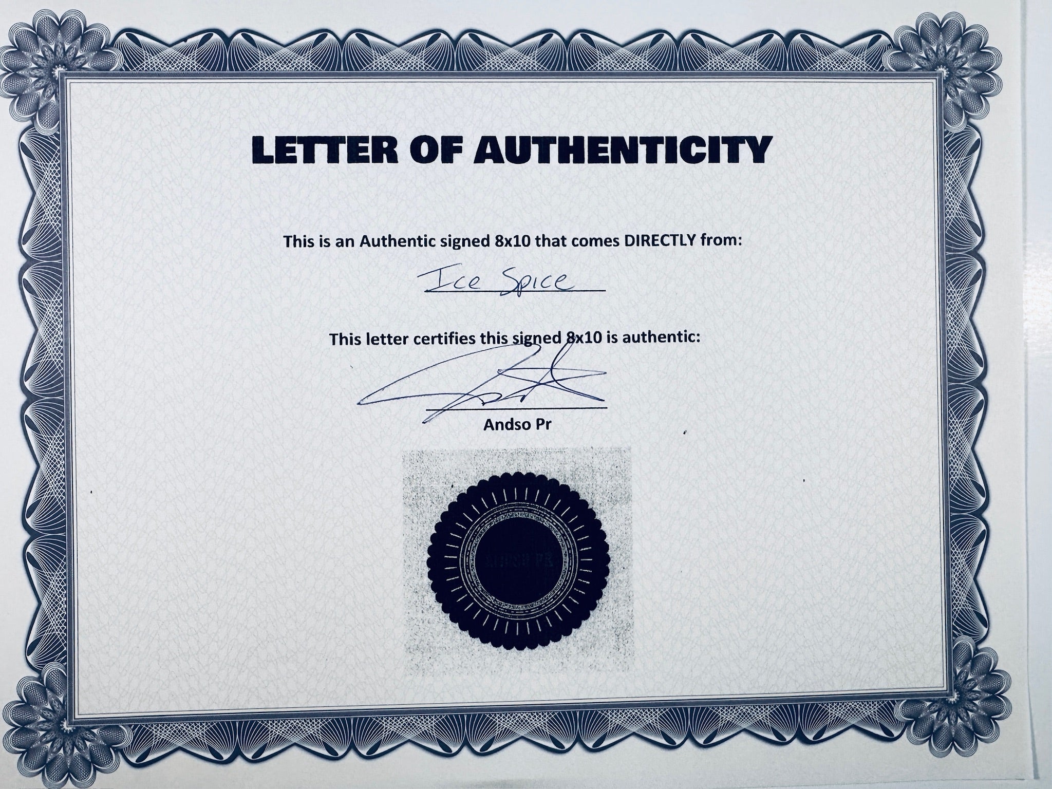 A Letter of Authenticity with a decorative blue-patterned border, certifying an authentic signed 8x10 coming directly from Ice Spice, featuring a dark circular seal graphic at the bottom.