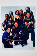 Cast photo from Ghostbusters featuring the main characters alongside director Ivan Reitman, with a bold silver ink autograph by Ivan Reitman.