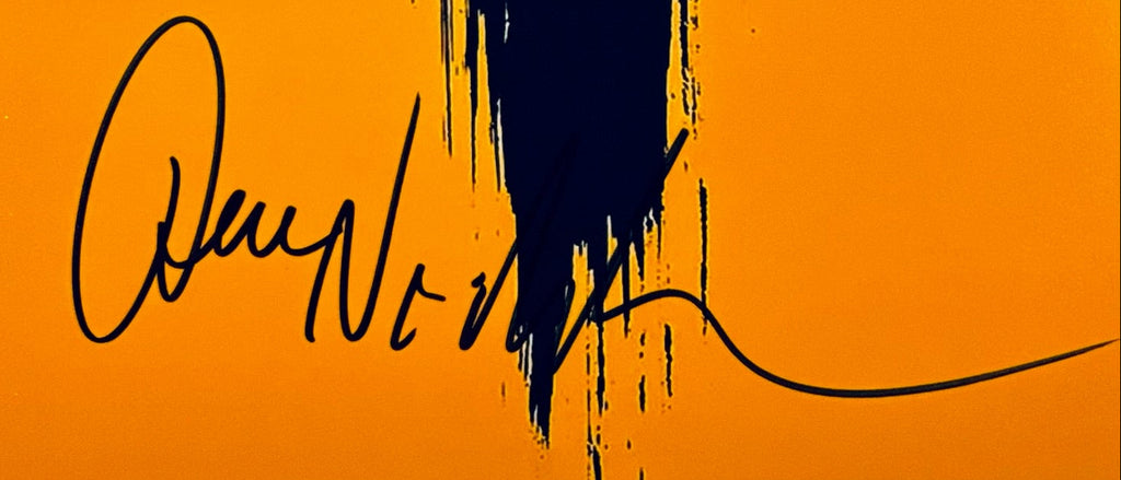A close-up view showing the authentic hand-signed signature of Jack Nicholson on a matte photograph.