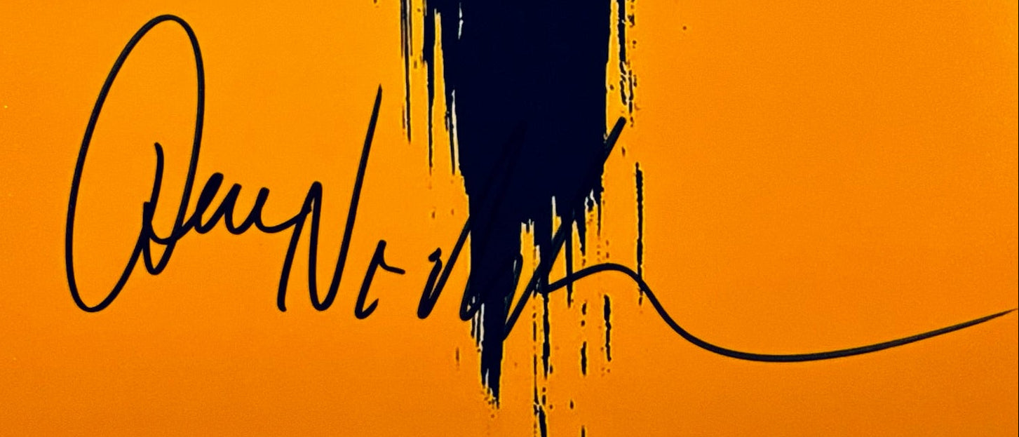 A close-up view showing the authentic hand-signed signature of Jack Nicholson on a matte photograph.