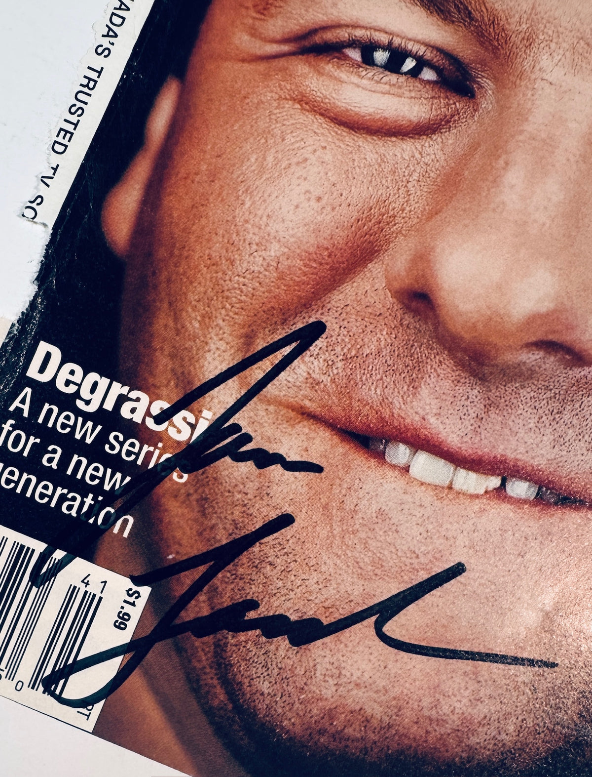 Close-up of James Gandolfini's handwritten signature in black marker on a TV Guide magazine cover.