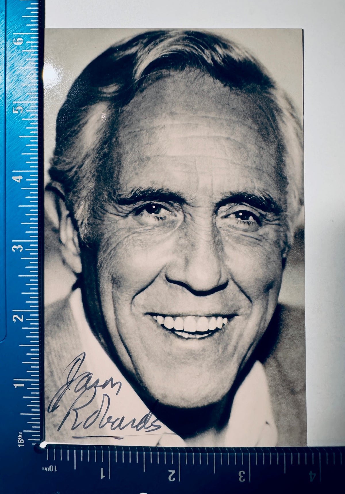 Jason Robards signed photo measured with ruler showing dimensions approx 4x6 inches.